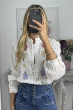 White shirt with colorful embroidered flowers